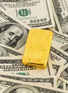 gold bars on dollar bills